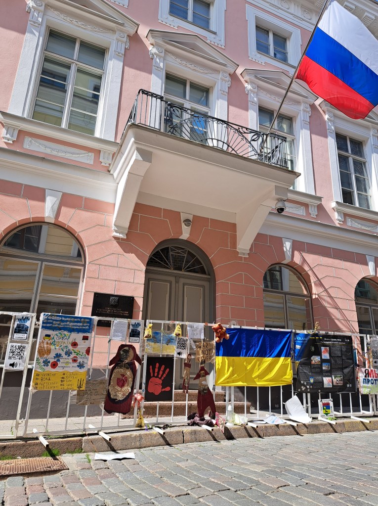 Posters and protest signs on a fence in front of the abandoned Russian embassy in Tallinn, Estonia.