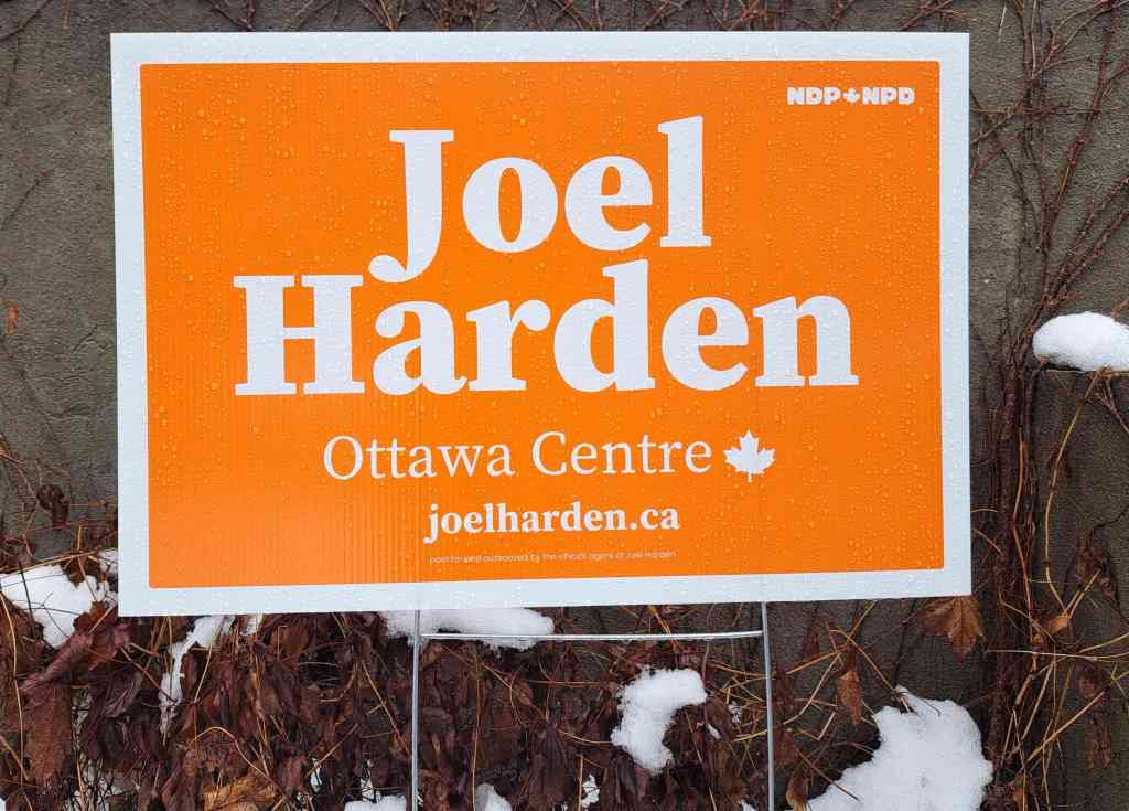 Orange and white lawn sign for Joel Harden, NDP candidate for Ottawa Centre in 2025 Canadian federal election.