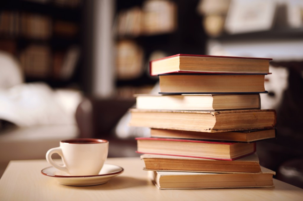 Image of a stack of books and a coffee cup  