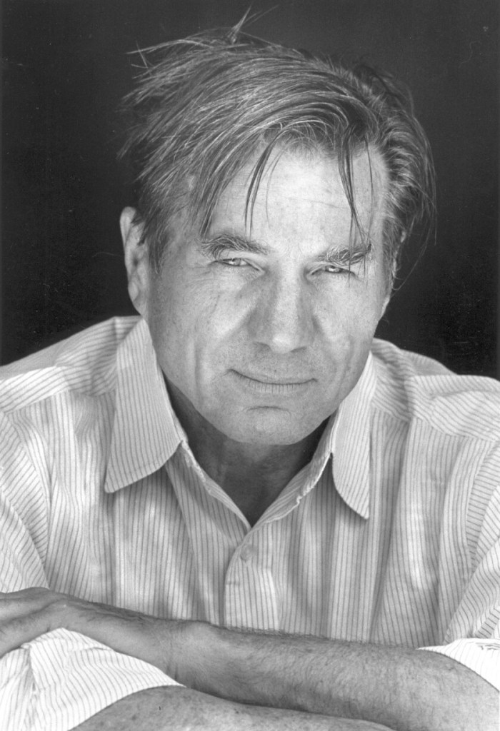 Black and white, head and shoulders  photo of American poet Galway Kinnell