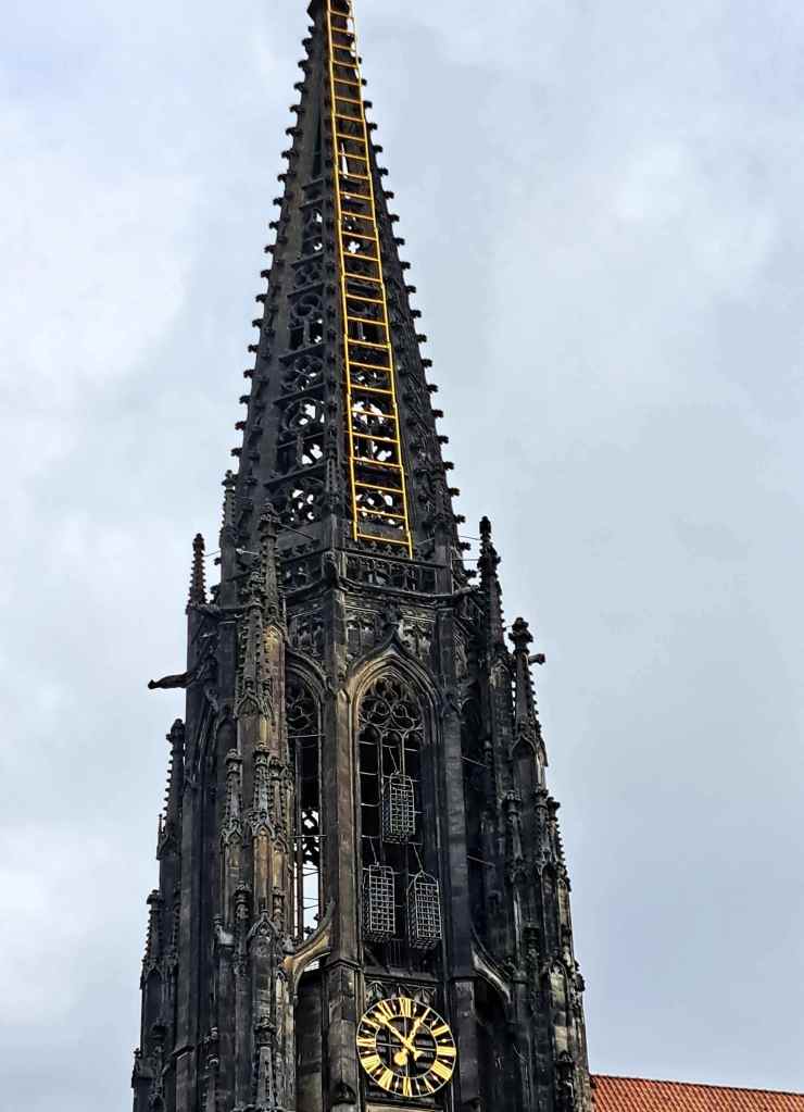 Metal cages suspended from the tower of St. Lamberti church in Münster, Germany. They contained the lifeless bodies of three radical Anabaptist leaders who led a revolt in 1534-35.The cages are still there.