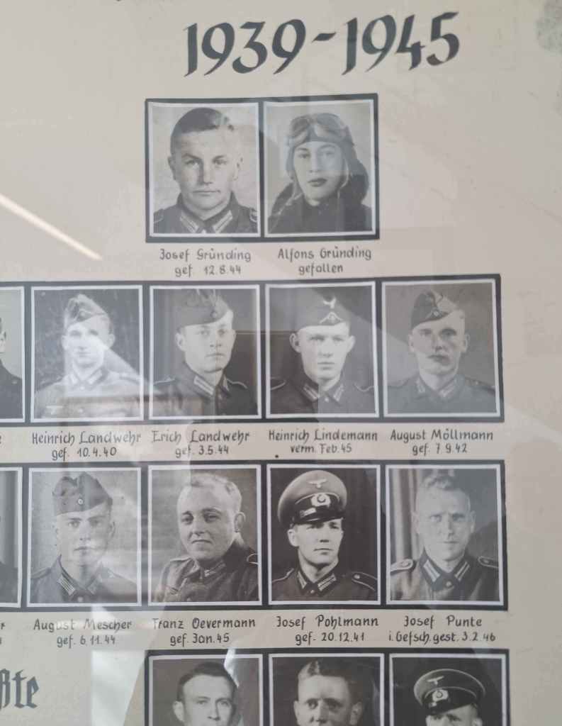 Black and white photo under glass of young men from and near Neuenkirchen, Germany who were killed in the two World Wars.